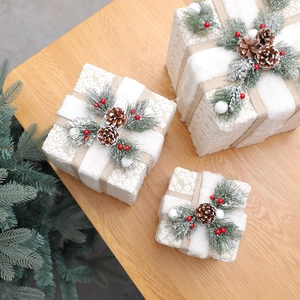 Three-piece Christmas gift box set in white and gold with pine cone and berry accents