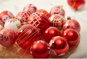 Detailed view of red and cream Christmas balls with glitter textures and snowflake patterns