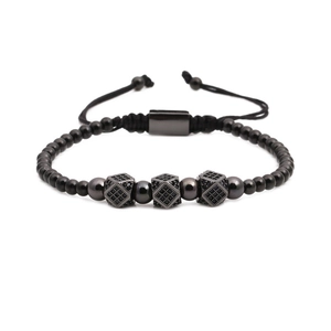 Macro detail of men's beaded bracelet featuring three micro-pave black zircon cubes