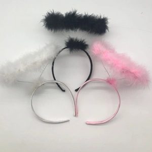 Detailed view of three halo headbands in black white and pink feathers for party costumes