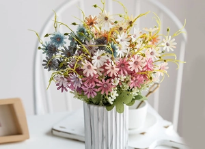 Colorful artificial daisy bouquet in white marble vase for elegant home interior decor