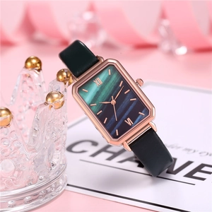 Detail of square rose gold watch with gradient dial and black leather strap
