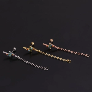 Detailed view of lightning bolt cartilage earrings with chains in gold and silver