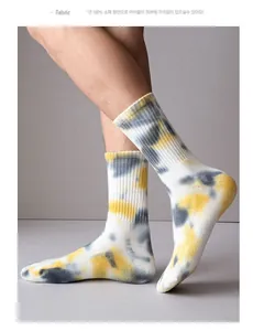 Detail of 100% cotton tie-dye socks in yellow and grey showing soft fabric texture