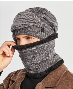 Close-up of grey knitted winter hat and neck gaiter with warm faux fleece lining