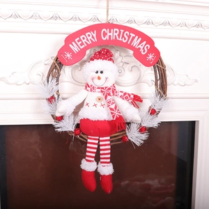 Christmas wreath featuring a plush snowman with long red and white legs on a vine ring