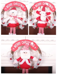 Close-up of Santa, snowman and elk plush figurines on woven wooden Christmas wreaths