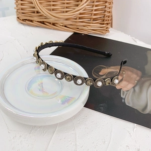 Detailed macro view of vintage Baroque headband with pearls and rhinestones