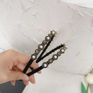 Detailed macro view of vintage Baroque headband with pearls and gold metal ornaments