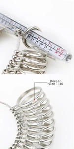 Detailed ring sizer set showing graduated measuring stick with US UK HK sizes 1-30