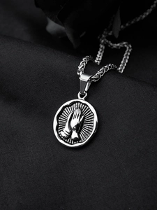 Macro view of silver stainless steel pendant featuring detailed praying hands engraving