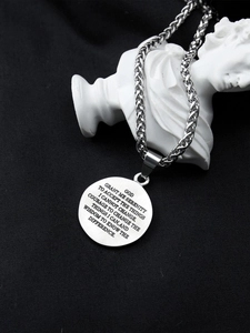Detailed view of silver praying hands serenity prayer pendant on a wheat chain necklace