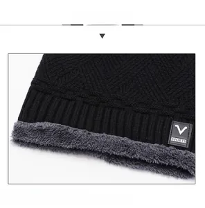 Detailed view of black knitted winter hat with warm fleece lining and V SPORTS label