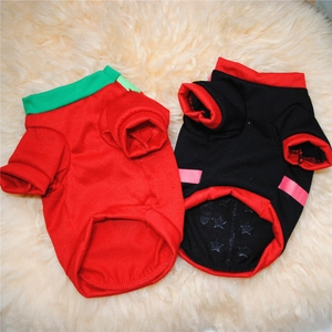 Flat lay of red and black cotton knit dog sweaters with star print lining on plush background