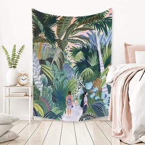 Detailed view of bohemian tropical rainforest tapestry hanging in a cozy bedroom