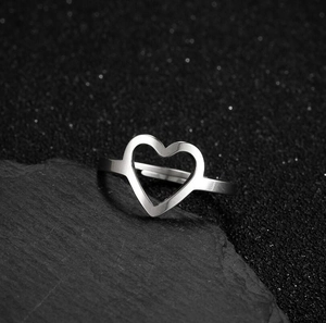 Detailed macro view of the open heart ring on a luxurious black stone texture