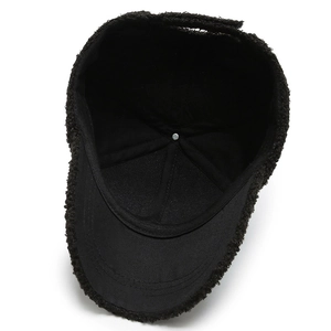 Interior view of black faux shearling baseball cap with cotton lining and metal button