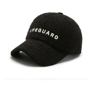 Detail view of black lambswool baseball cap featuring white LIFEGUARD embroidery