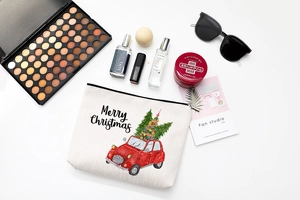 Flat lay of linen Christmas makeup bag with red vintage car and cosmetic accessories