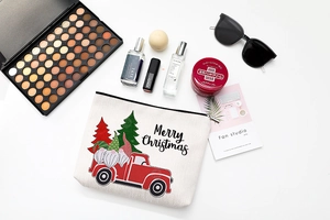 Detailed flat lay of a Merry Christmas linen toiletry bag with festive gnome print