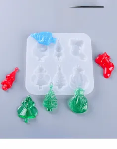 Macro detail of Christmas silicone mold set with colorful resin Santa and snowman shapes