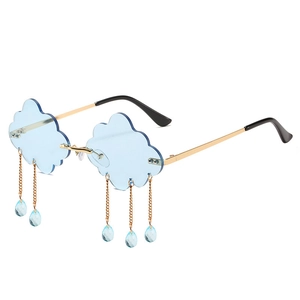 Frameless cloud-shaped sunglasses with light blue lenses and gold teardrop pendants