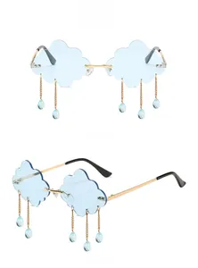 Detailed view of cloud-shaped rimless sunglasses with gold chains and blue rain droplets