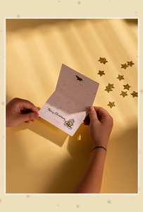 Close-up of pink Christmas card interior with Merry Christmas tree illustration