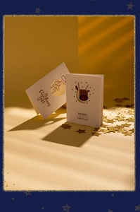 Close-up of trifold Christmas cards with reindeer and mistletoe cut-out designs