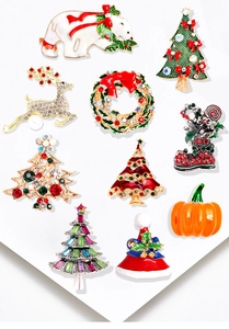 Detailed close-up of colorful Christmas enamel brooches with rhinestones and holiday motifs