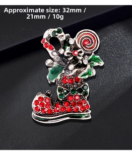 Detailed macro view of a 32mm x 21mm Christmas boot brooch with red and green rhinestones