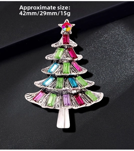 Close-up of a colorful rhinestone Christmas tree brooch with size measurements