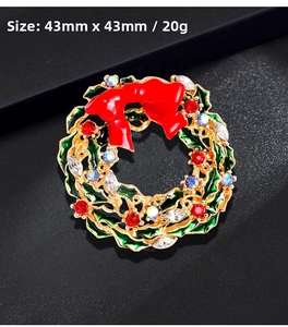 Detail view of a 43mm Christmas wreath brooch with colorful rhinestones and red bow
