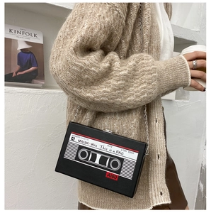 Detailed view of creative black cassette tape crossbody bag with sleek metal chain strap