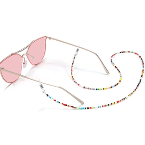 Colorful beaded eyewear chain with metal accents on sunglasses over a white background