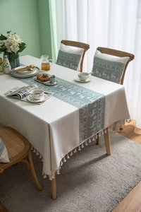 Detailed view of Nordic cotton linen tablecloth with reindeer pattern and tassels
