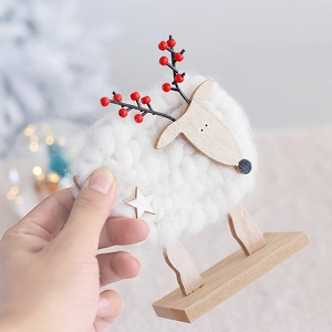 Handcrafted white wool reindeer ornament with natural wood base for Christmas decor