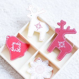 Nordic wooden Christmas ornaments set featuring reindeer, snowflakes and bells in a box