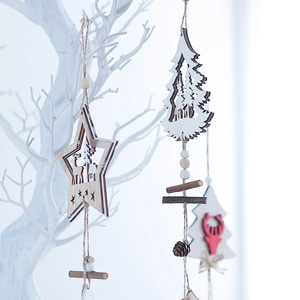 Nordic wooden Christmas ornaments with star and deer patterns hanging on white branches