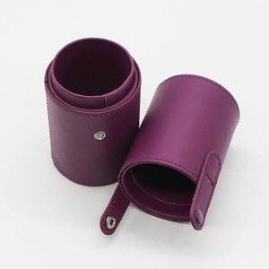 Detail of purple PU leather makeup brush holder with secure snap button closure