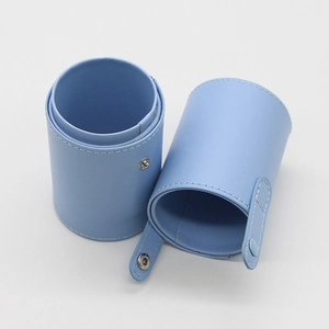 Blue marble PU leather makeup brush holder with button clasp detail on white background