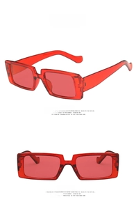 Detail view of stylish translucent bright red rectangular sunglasses with a retro design