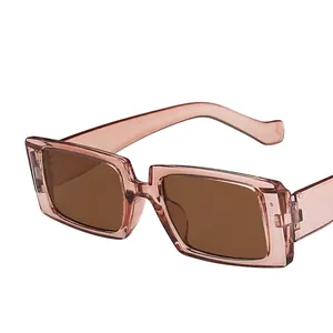 Fashionable square sunglasses with transparent pink frame and tinted brown lenses