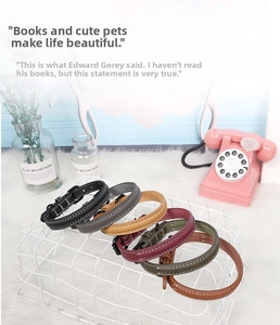 Close-up of adjustable faux leather pet collars in multiple colors with white stitching