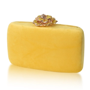 Yellow velvet evening clutch bag featuring a luxurious crystal flower clasp on white background