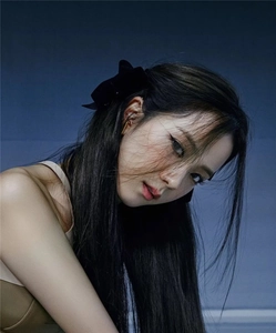 Detail showing two velvet black bow hair clips styled on a young girl's hair