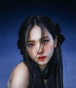 Portrait of elegant woman wearing chic black velvet bow hair clips on dark long hair