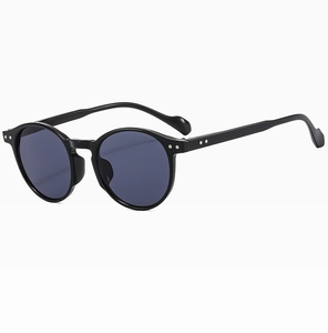 Detail of matte black round sunglasses frame with silver rivets and smoke lenses