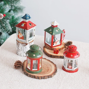 Christmas iron candle lantern with festive patterns on wood logs in a warm setting