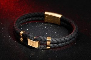 Detail of double-layer black woven leather bracelet with golden stainless steel cross clasp